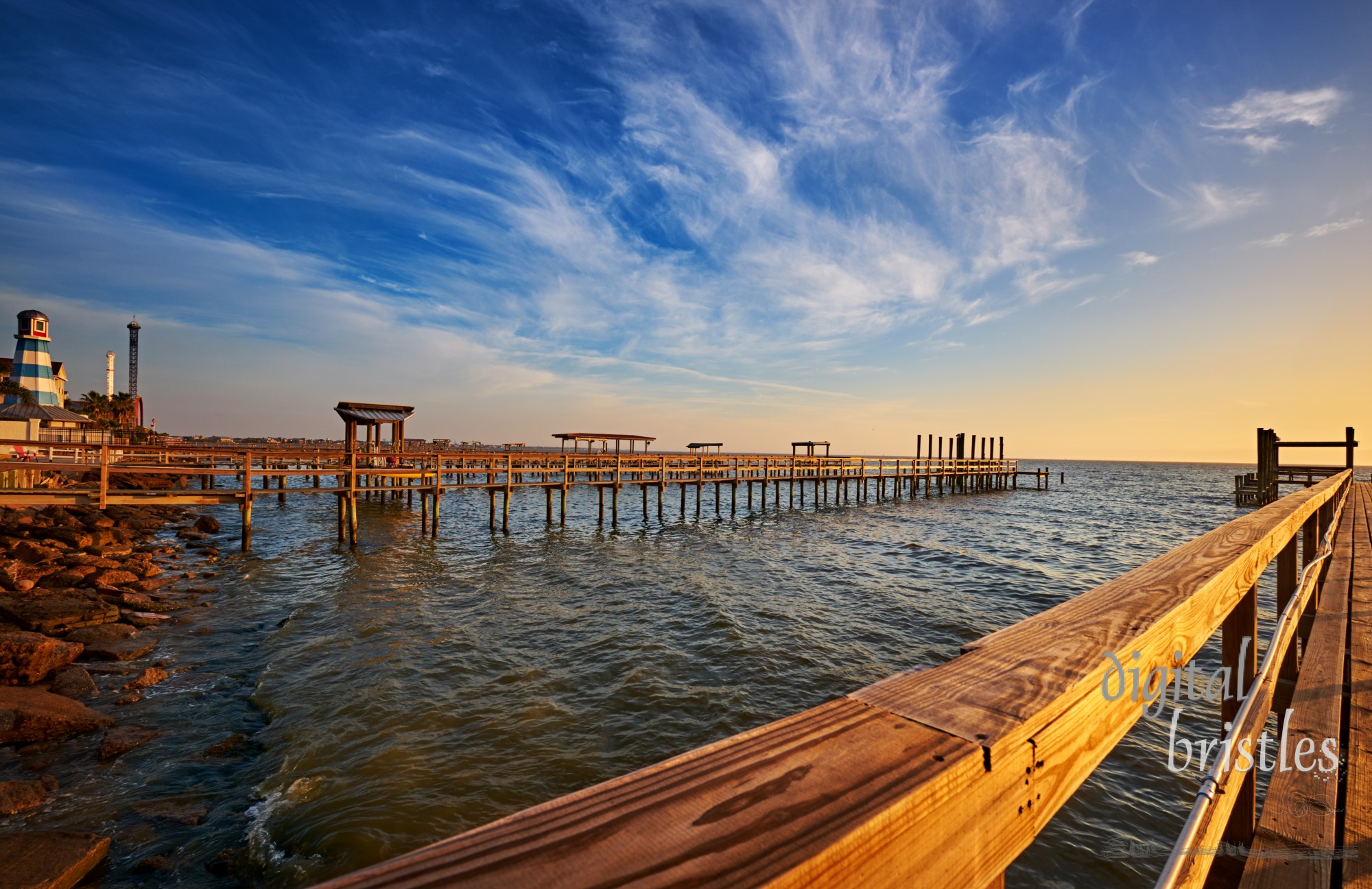 Wooden docks stretch into Galveston Bay, many layers deep