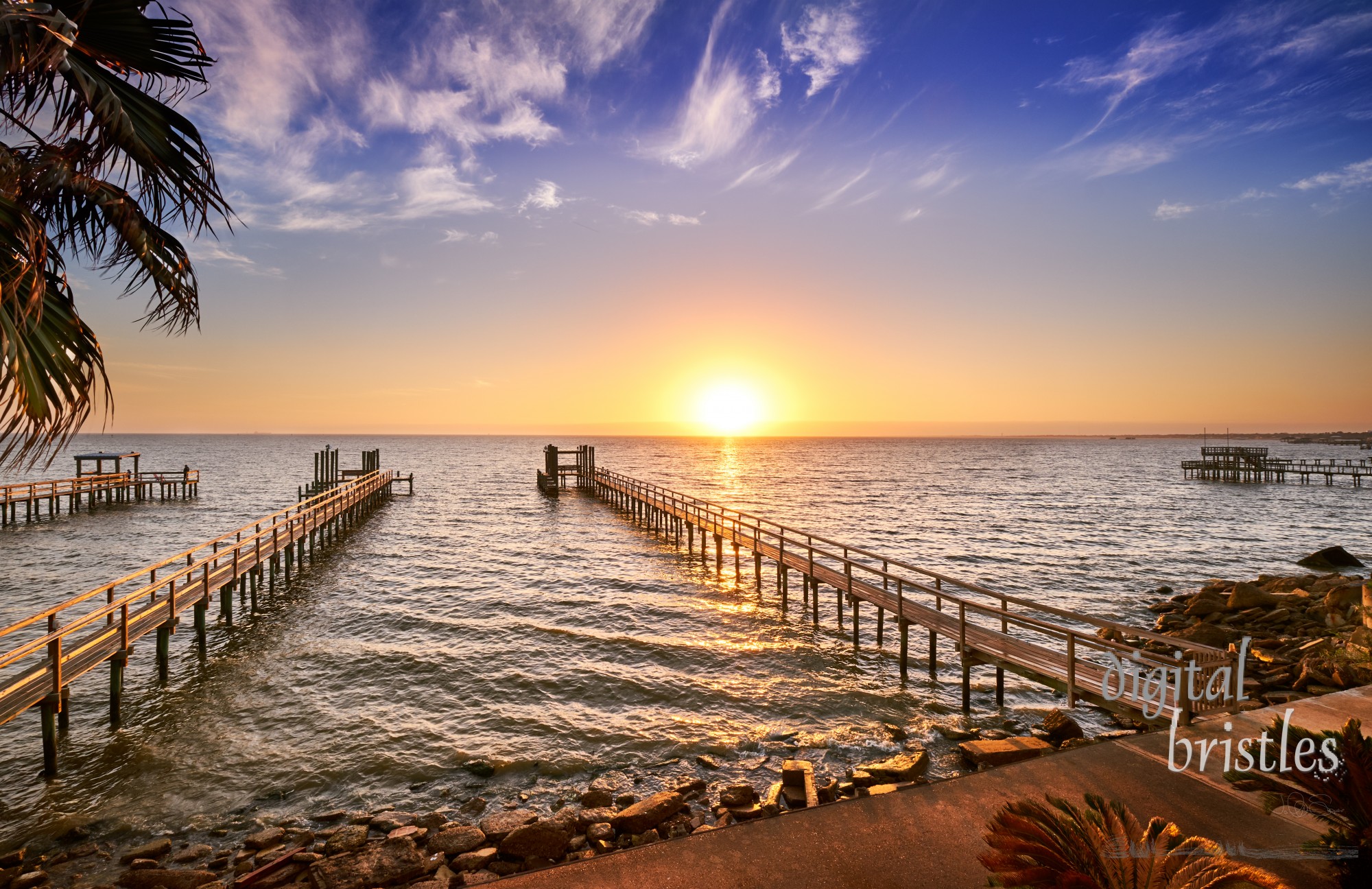 Long wooden fishing docks stretch out into Galveston Bay, Texas