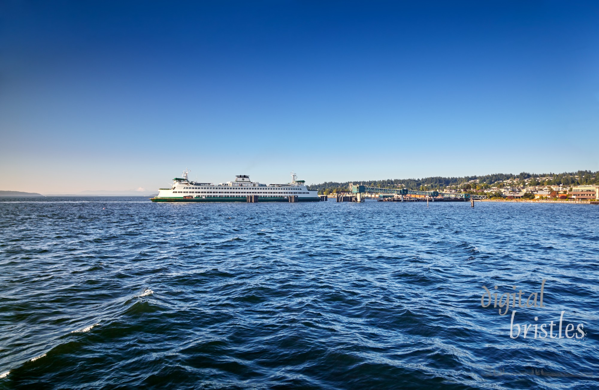 Washington State ferry arrives at the Edmonds dock late on a sunny Summer afternoon