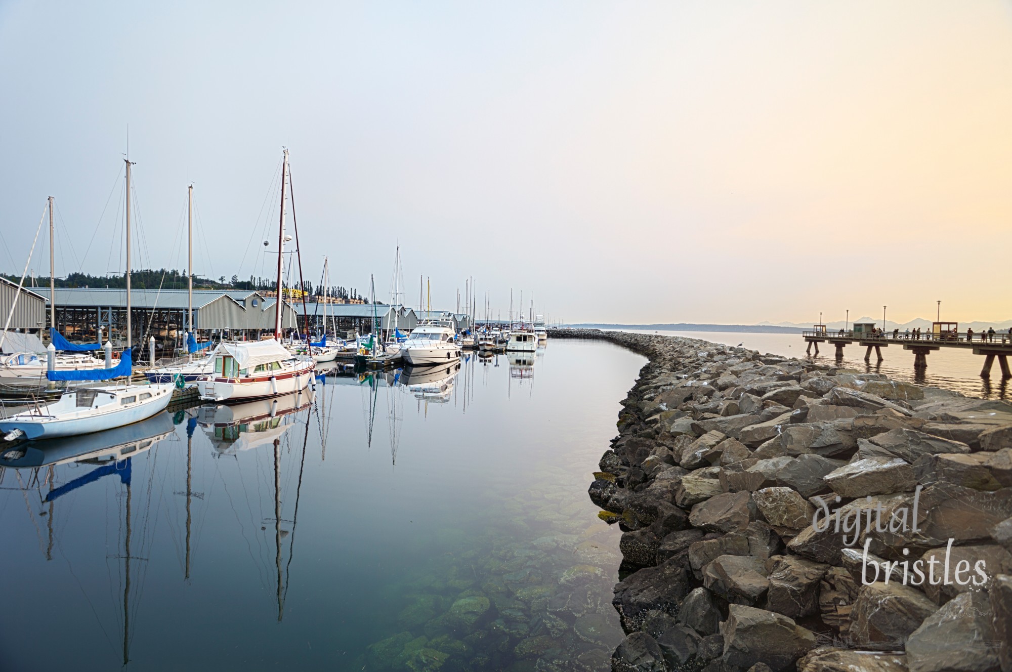 Hazy summer sun going down over the marina in Edmonds