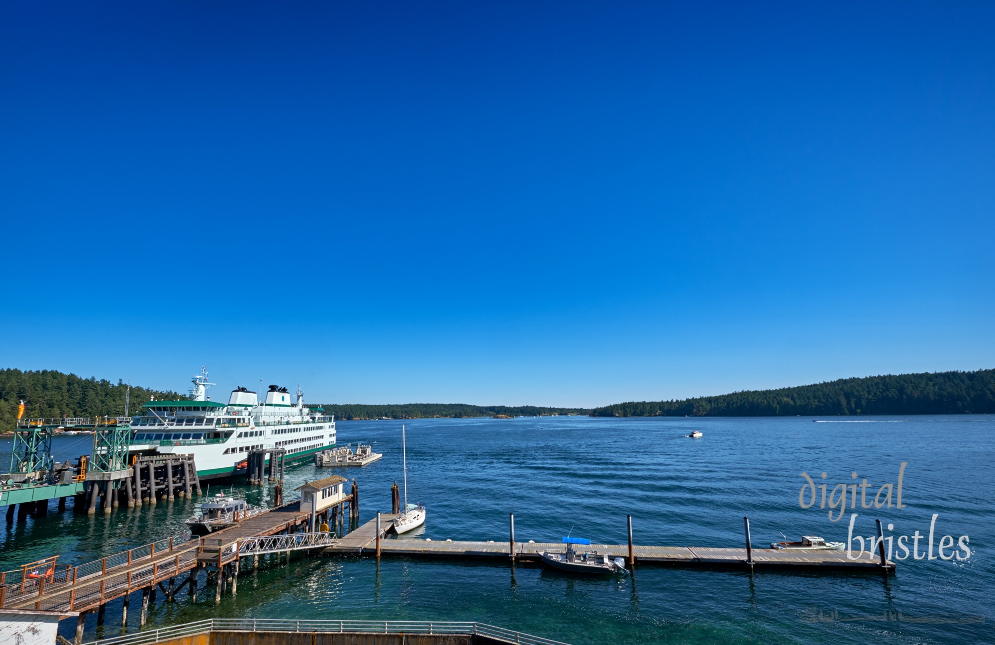 Washington State ferry arriving at the dock on Orcas Island, Washington, on a sunny Summer afternoon