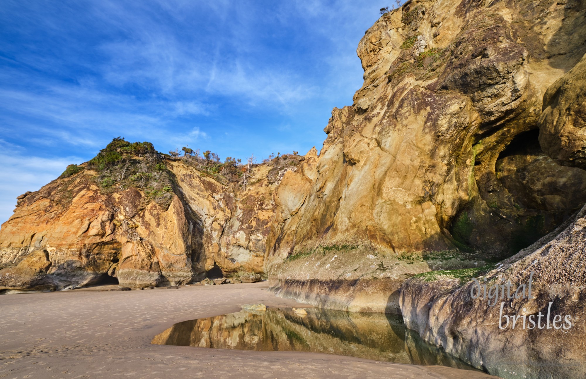 Cliffs and caves at Hug Point, Arch Cape, Oregon. The old road carved out of the cliff starts on the right