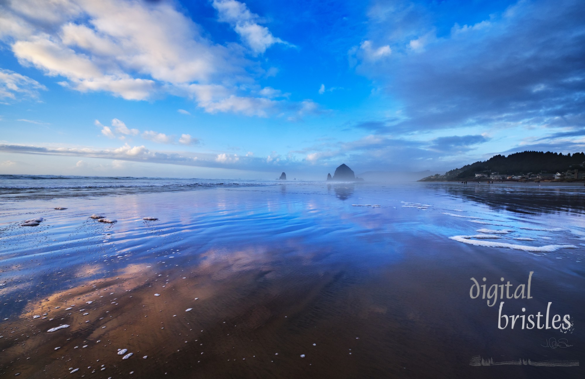 Cannon Beach on a msty Winter afternoon, with Haystack Rock and the Needles facing into the haze 