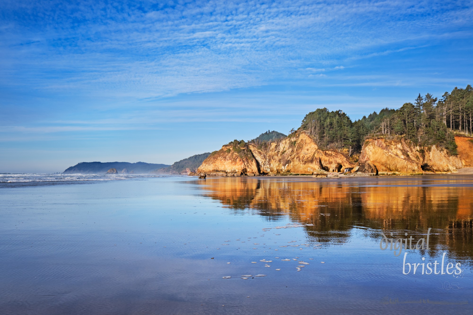 View from Hug Point north to Cannon Beach and Haystack Rock at low tide on a Winter afternoon