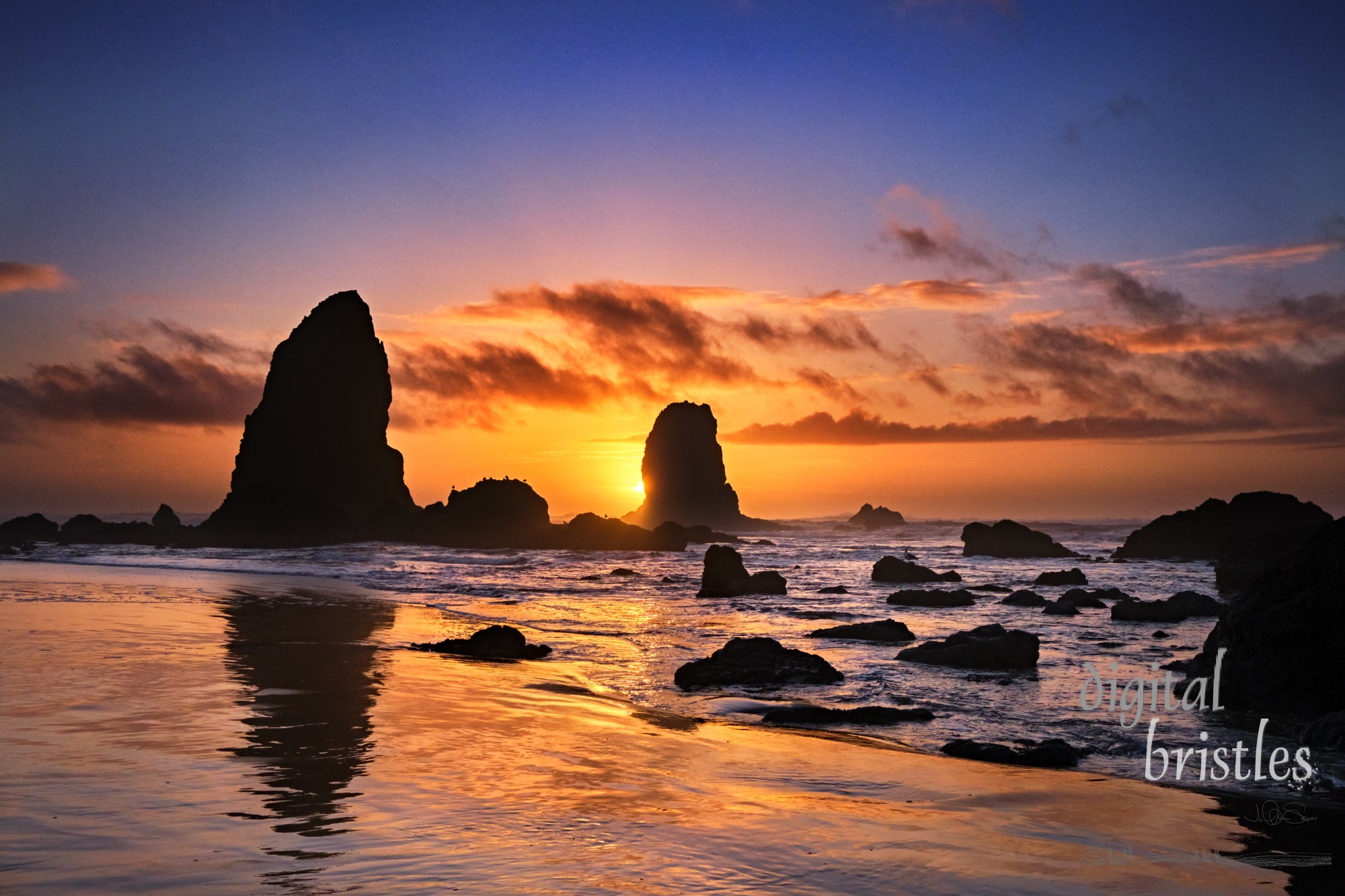 Gentle flow of water into and out of tide pools by Haystack Rock and The Needles, Cannon Beach, Oregon