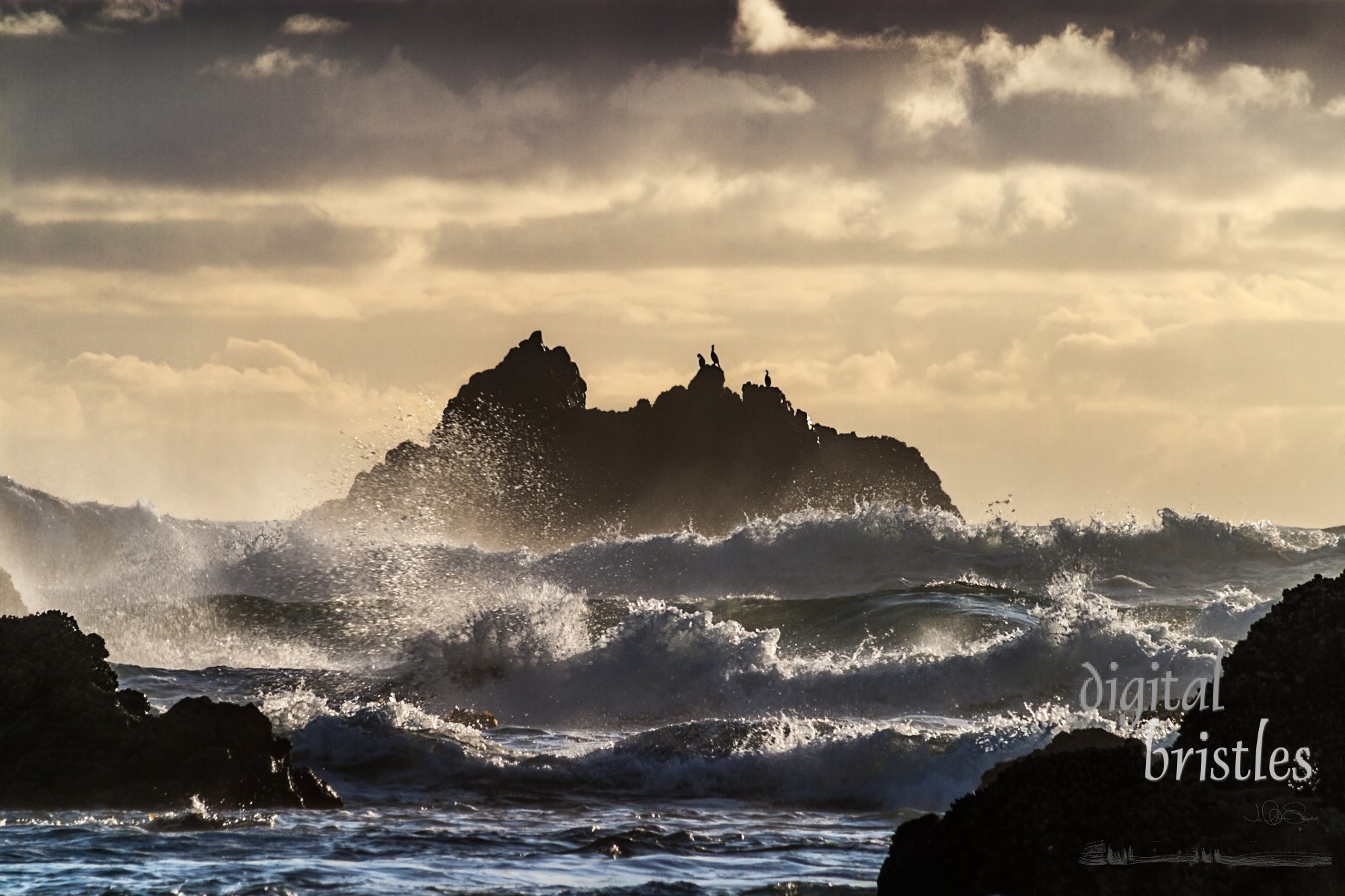 Waves splashing as they hit the rocks off Cannon Beach, Oregon, at sunset
