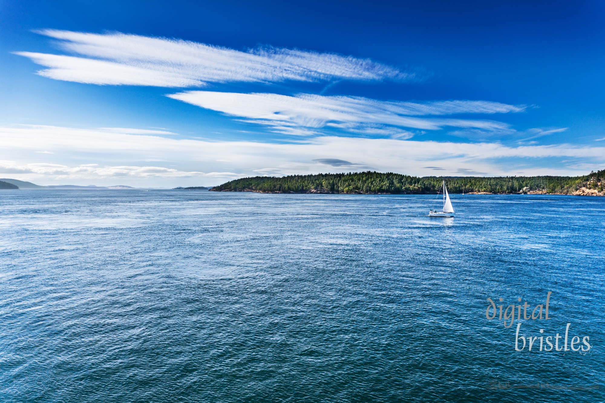 Sailboat on a calm, sunny Summer day in the San Juan Islands, Washignton