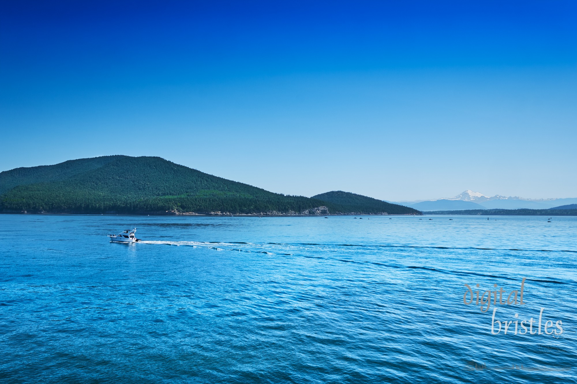 Summer weekend boaters enjoy calm seas and scenic views of Mt Baker in the San Juan Islands, Washington