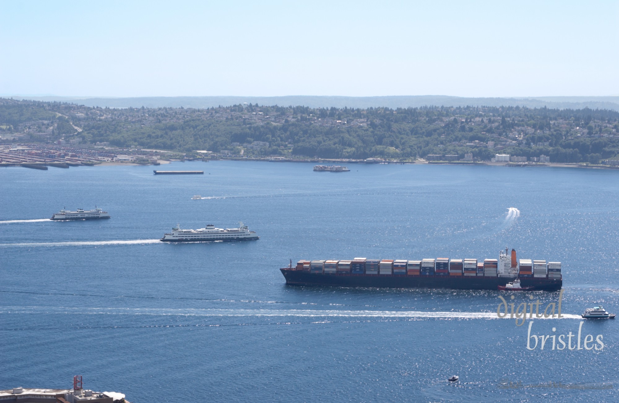 Container ship, tug boat, ferries and barges on their way in or out