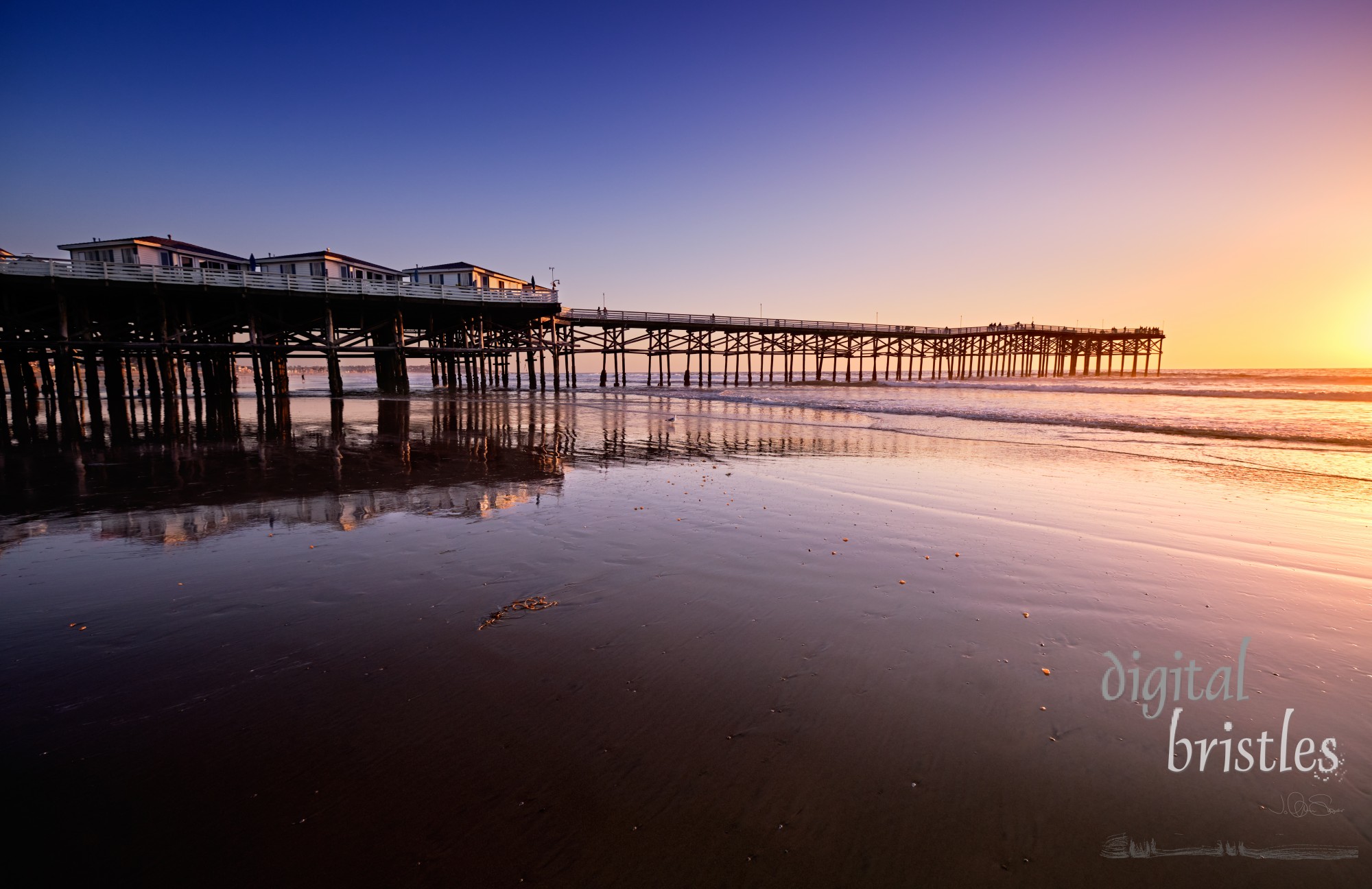 Sunset watchers at the end of Crystal Pier in Pacific Beach wait for the sun to go down