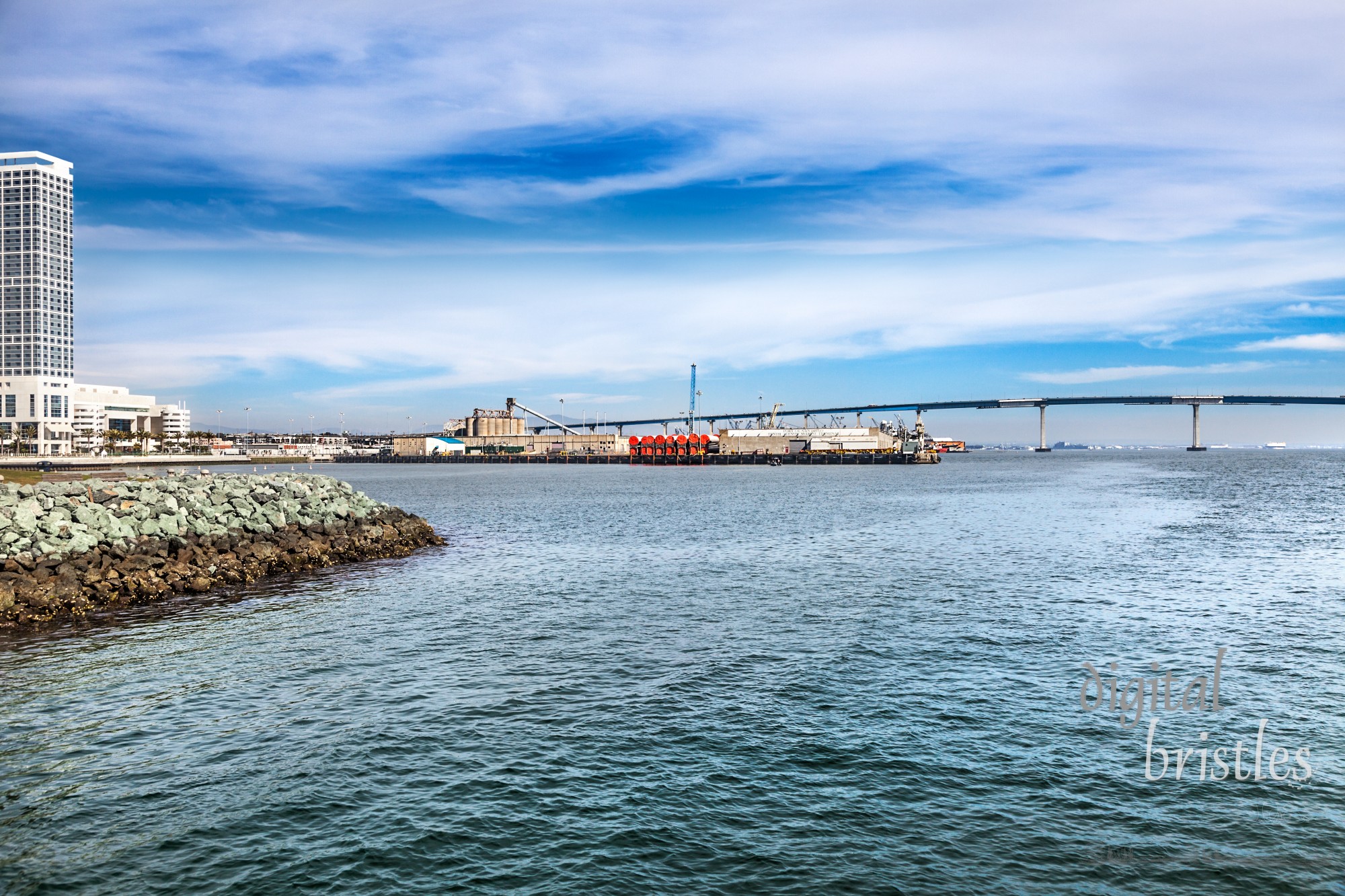 Port of San Diego Tenth Avenue Marine Terminal in San Diego Bay. Curved Coronado Bay Bridge in the background