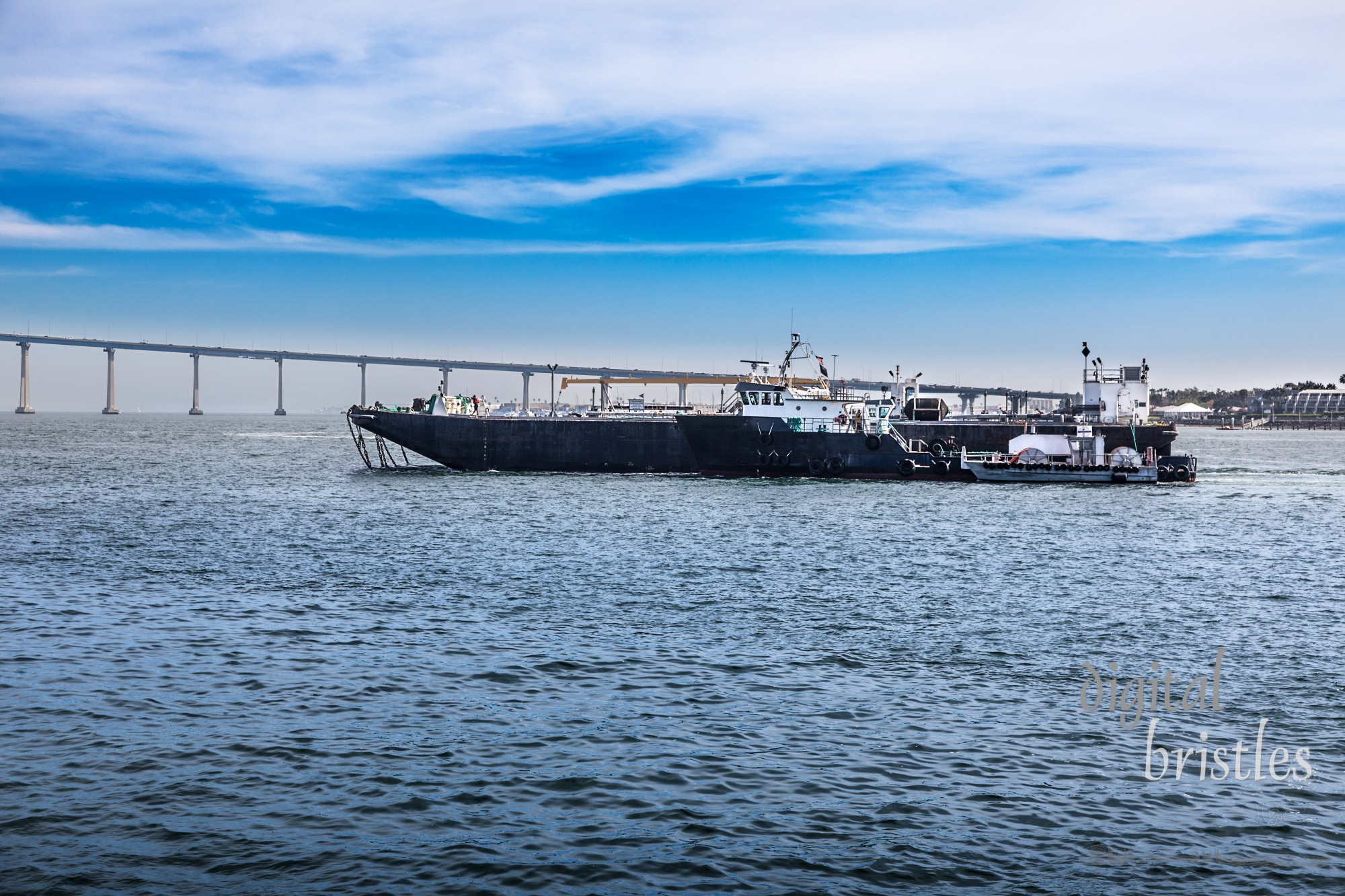 Harbor pilot escorting ship through San Diego Bay into Port of San Diego. Coronado Bay Bridge in the background