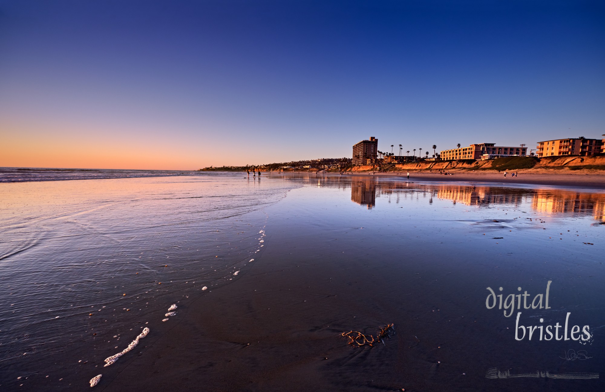 A sunset warmth lights up the oceanfront in Pacific Beach, on a clear Winter evening