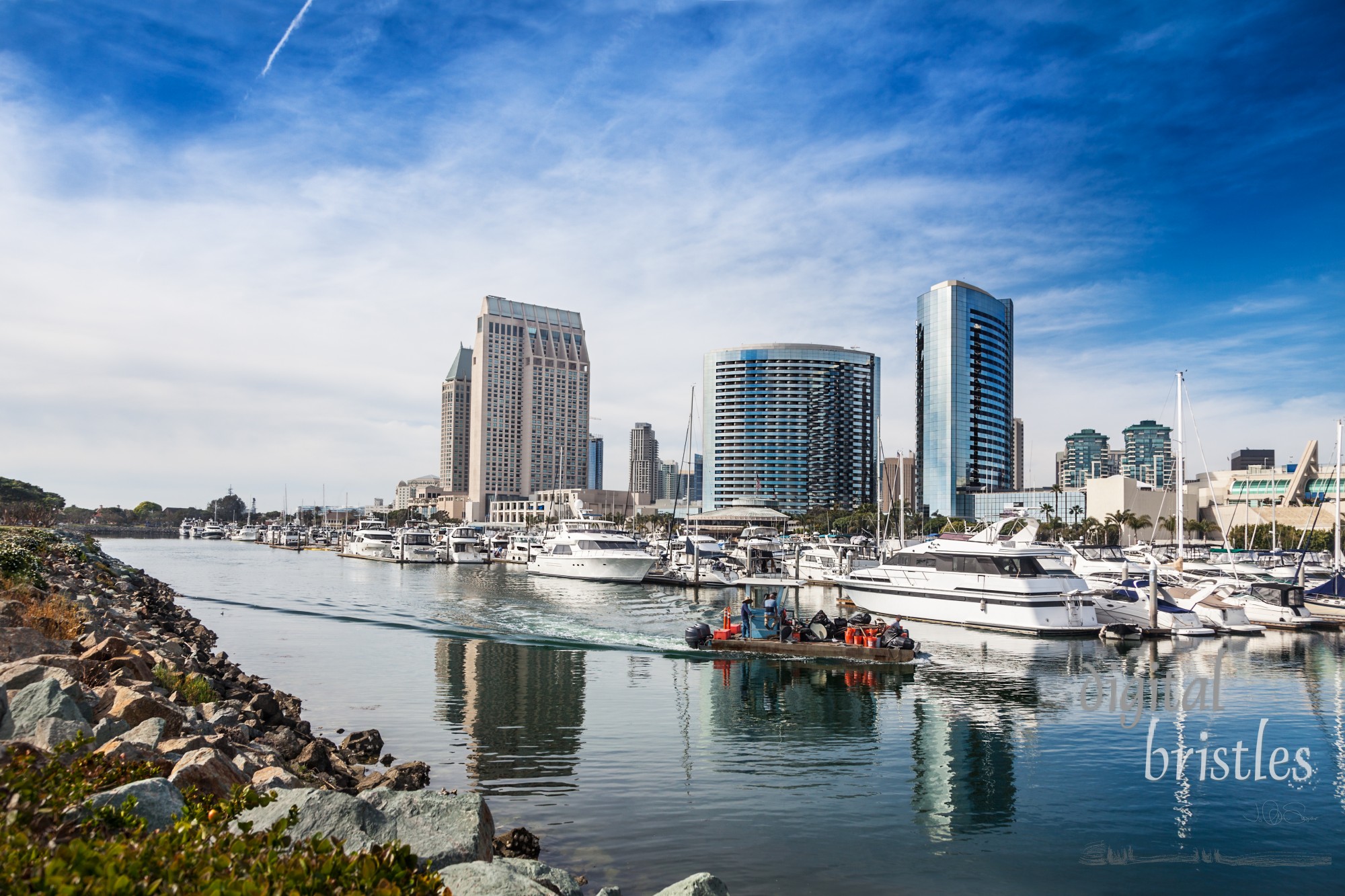 Marina maintenance and cleaning work boat moves around San Diego Embarcadero Marina docks