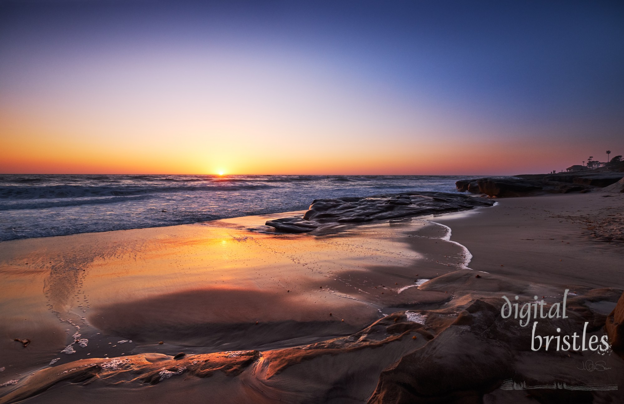 Sun hits the horizon at San Diego's Windansea Beach on a calm Spring evening