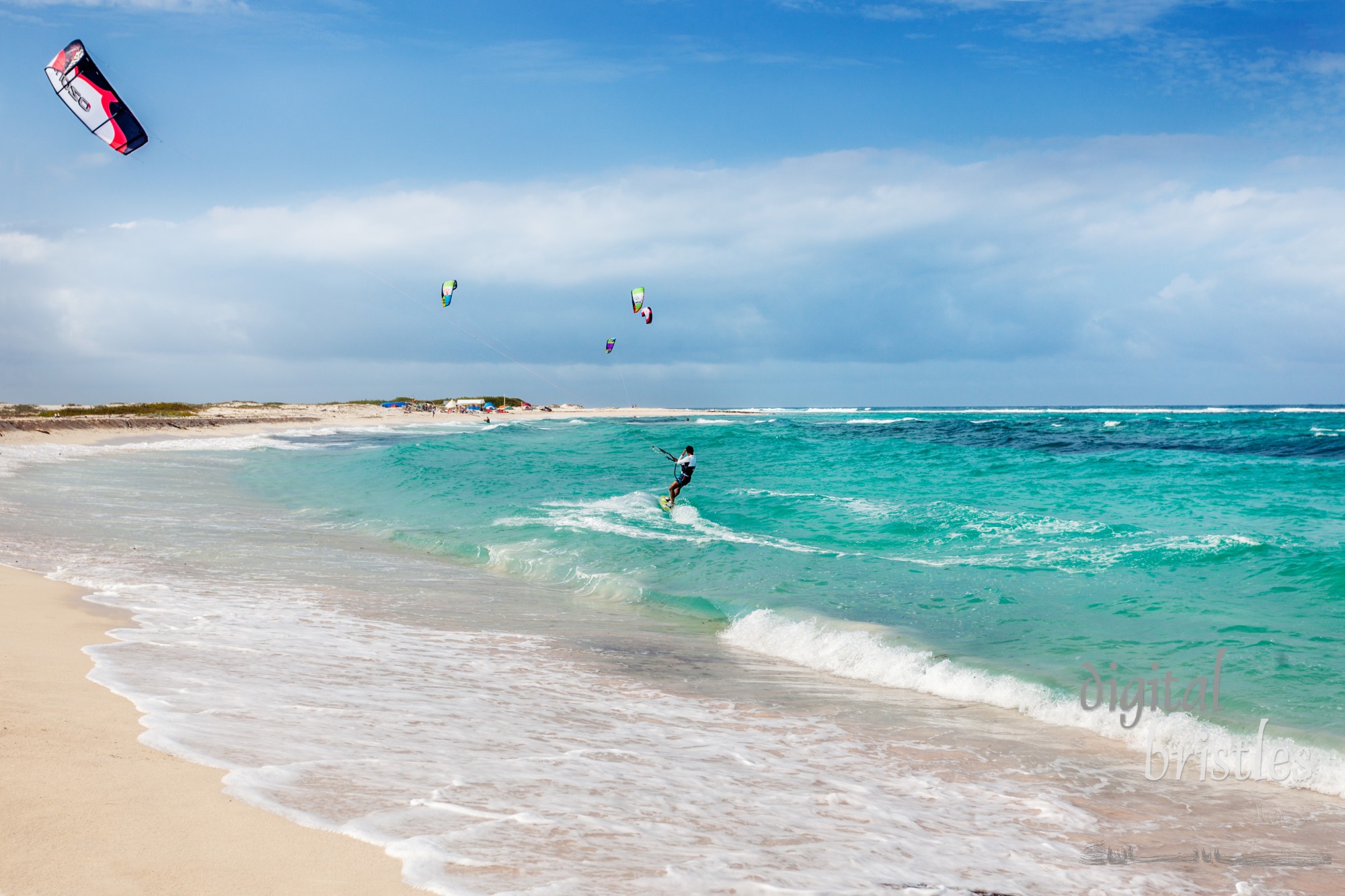 San Nicolas, Aruba, April 6, 2012.  A kitesurfer enjoys a sunny windy ride at Aruba's Boca Grandi beach. It's on the windy east side of the island where steady trade winds and challenging waves make this an ideal beach for kiteboarding or kitesurfing.