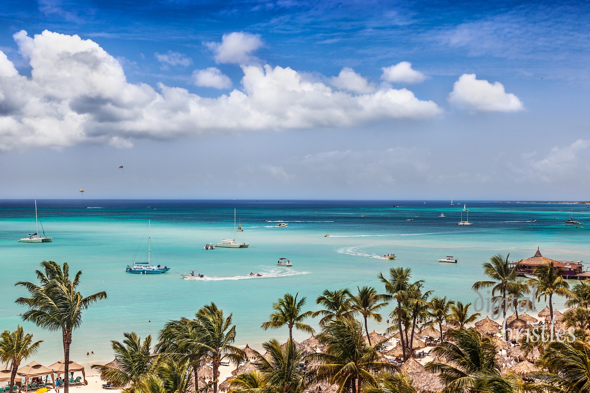 Sail and motor boats criss cross the bay at Palm Beach, Aruba