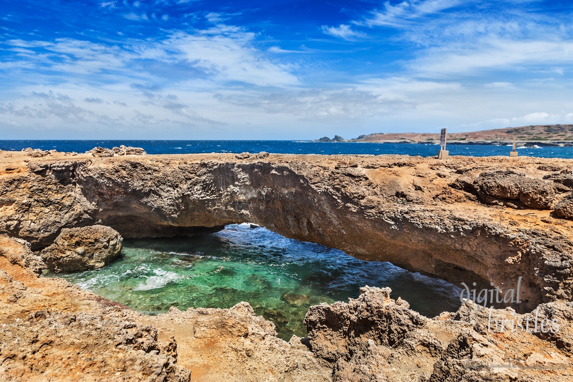 Natural limestone arch on Aruba's rocky north shore - known as Baby Bridge because it is smaller than the larger collapsed arch that used to be next to it