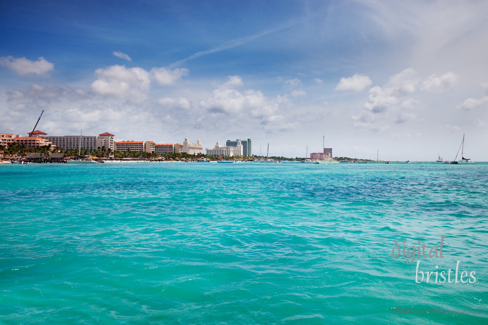 Resorts & hotels line Palm Beach, Aruba on a sunny Spring afternoon