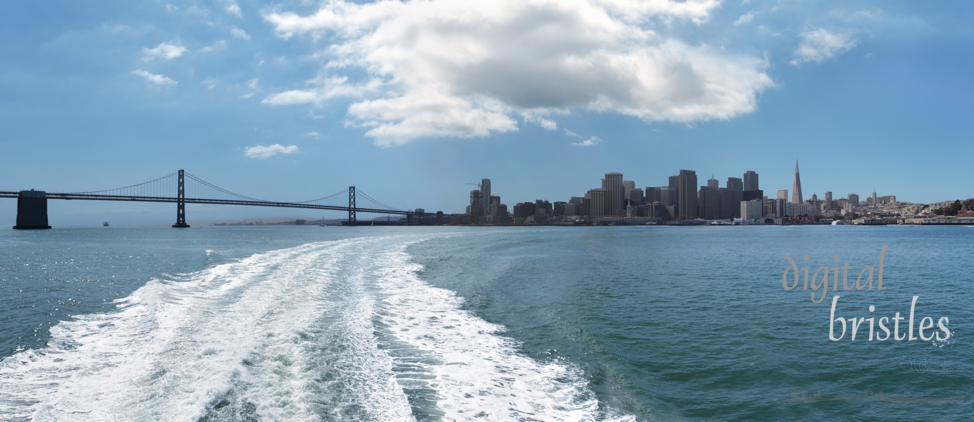 Curve of boat wake pointing back to the San Francisco waterfront