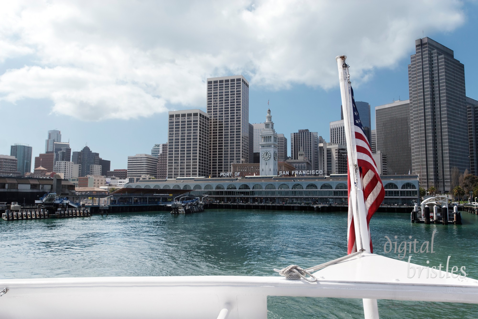 Boat flag flying as it leaves the ferry terminal in San Francisco