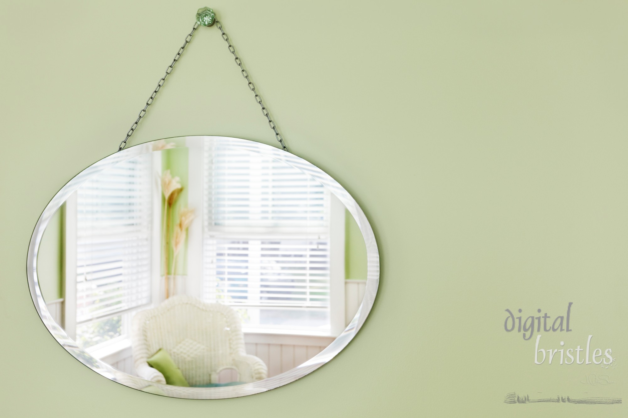 Oval mirror hanging on the wall in a summery beach house sitting area