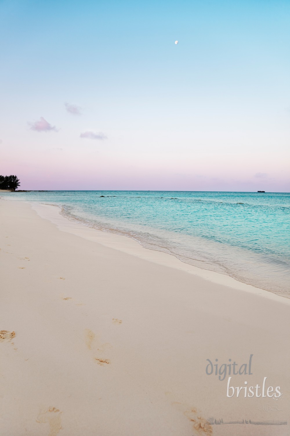 Seven Mile Beach, Grand Cayman, at sunrise with the moon over the water