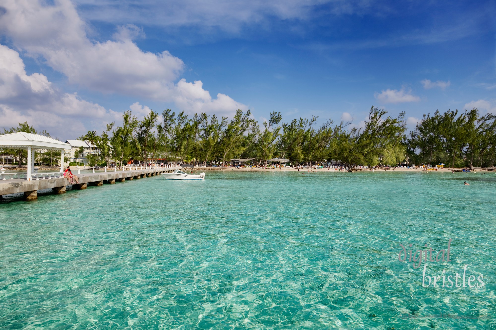 Family sitting on the dock watching at Rum Point, Grand Cayman