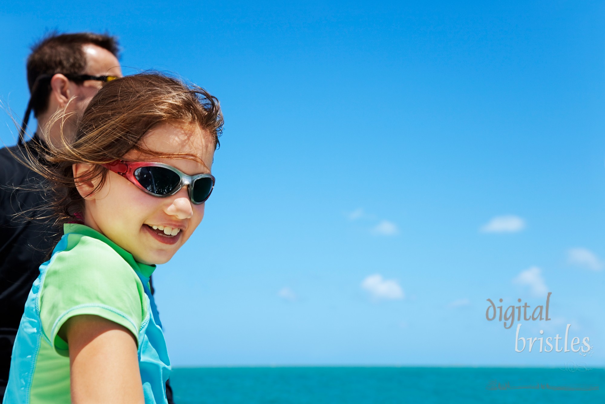 Young girl looks down over the side of a boat