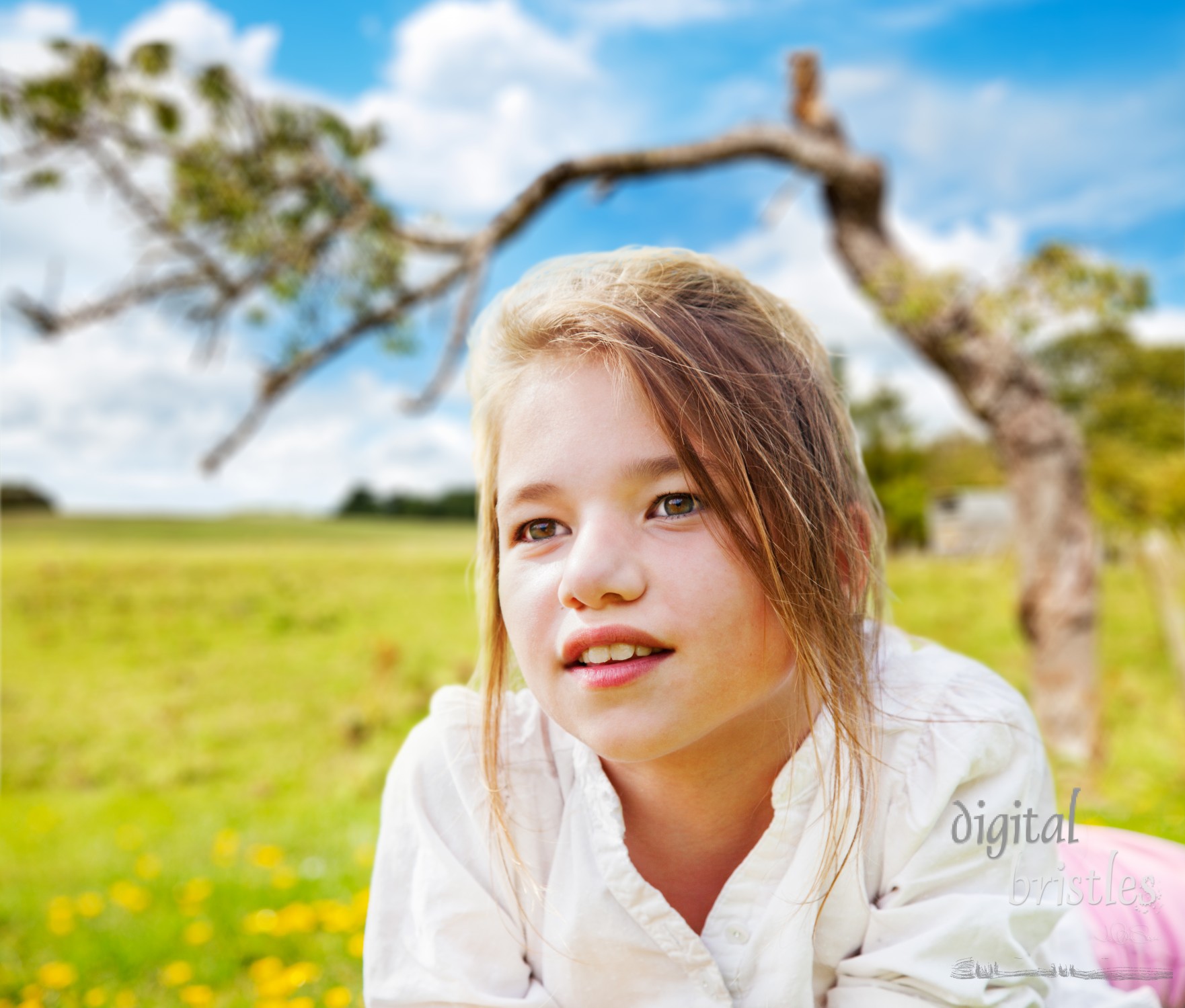 Young girl daydreaming in a sunny field