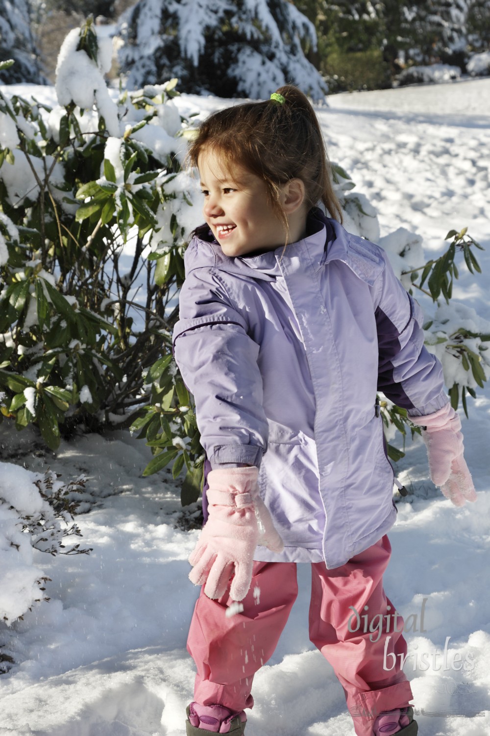 Young girl playing in the snow 