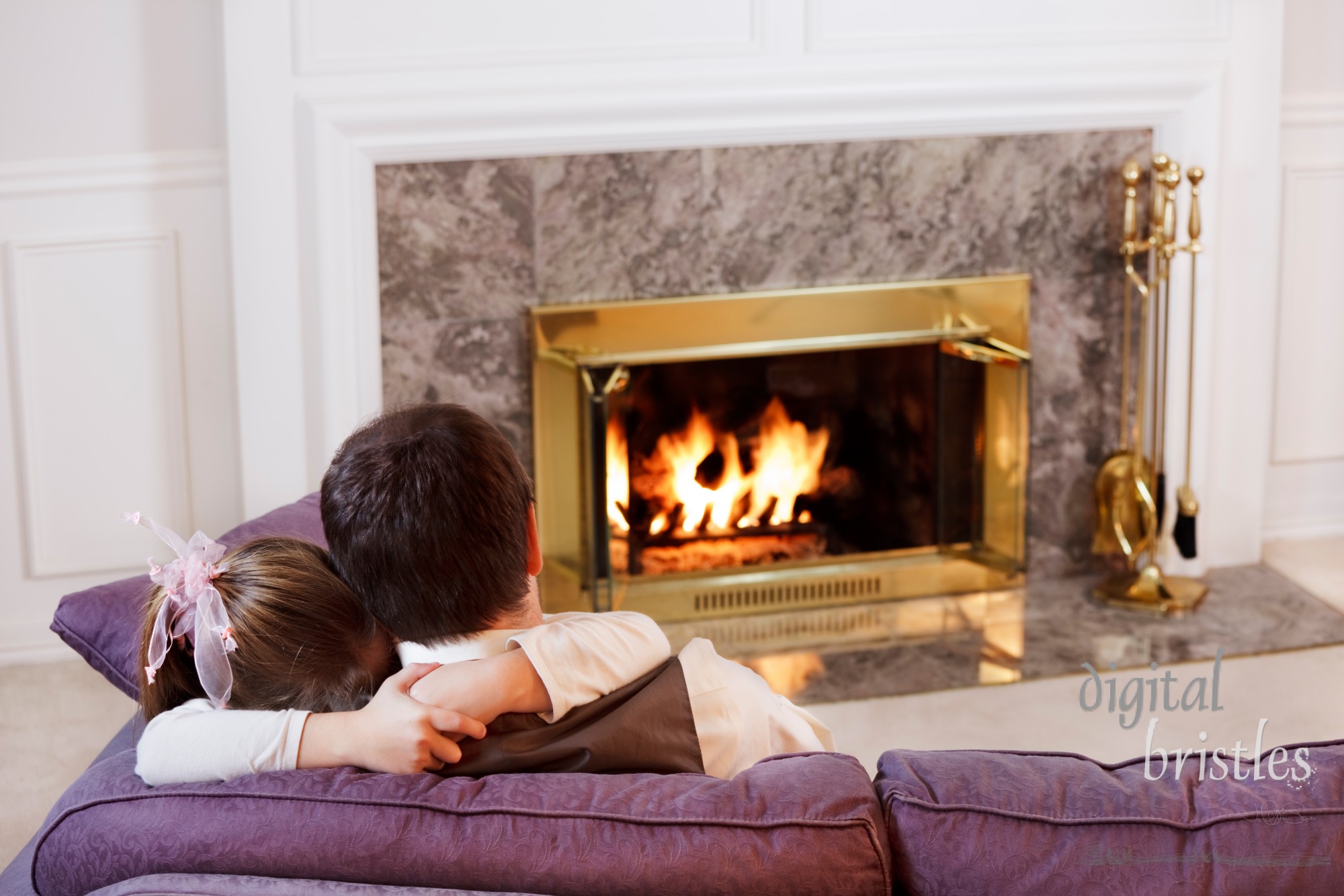 Daughter hugs her Dad by the light of a warm fire