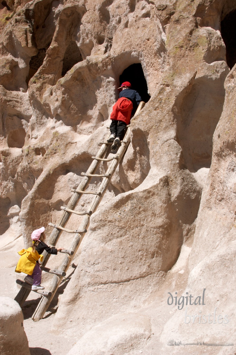 Older brother leads his sister on a climb