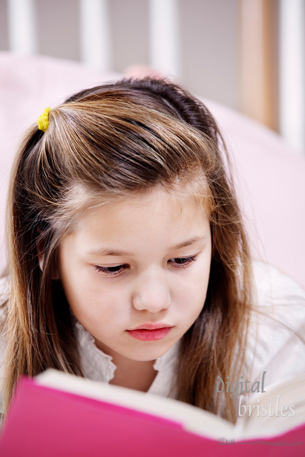 Young girl lying on the floor reading