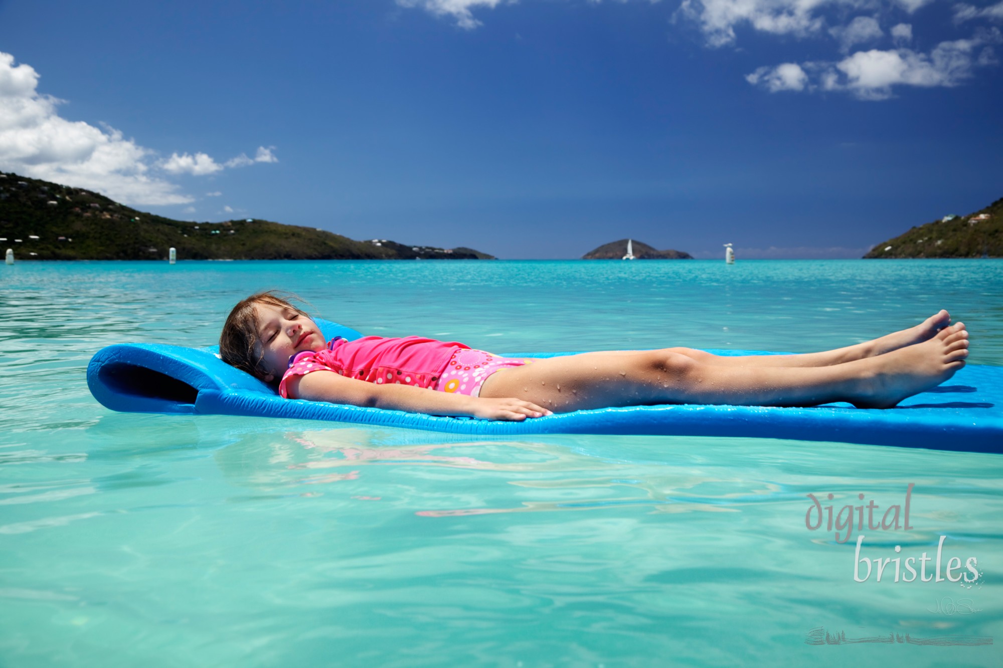 Young girl, eyes closed & covered in sand, floating peacefully in Magens Bay