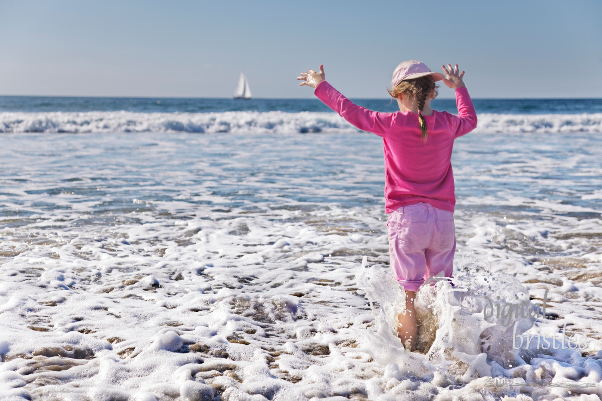 Young girl gets wetter than she planned as a wave soaks her