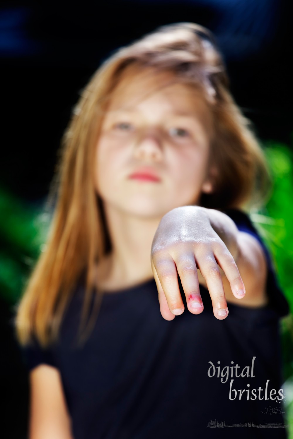 Young girl holds out fingers for inspection of bitten nails. Focus on nails.