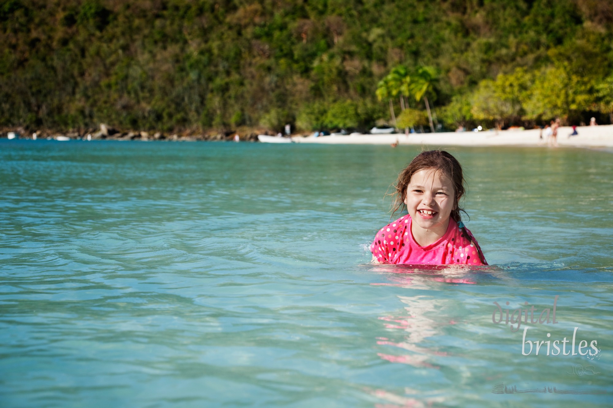 Young girl laughing in the water at Magens Bay