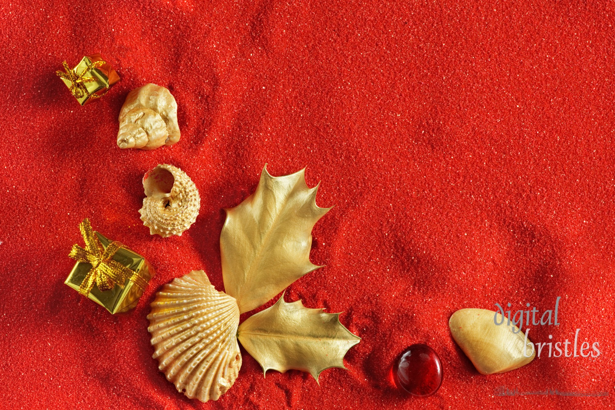 Gold shells, presents & holly on red sand