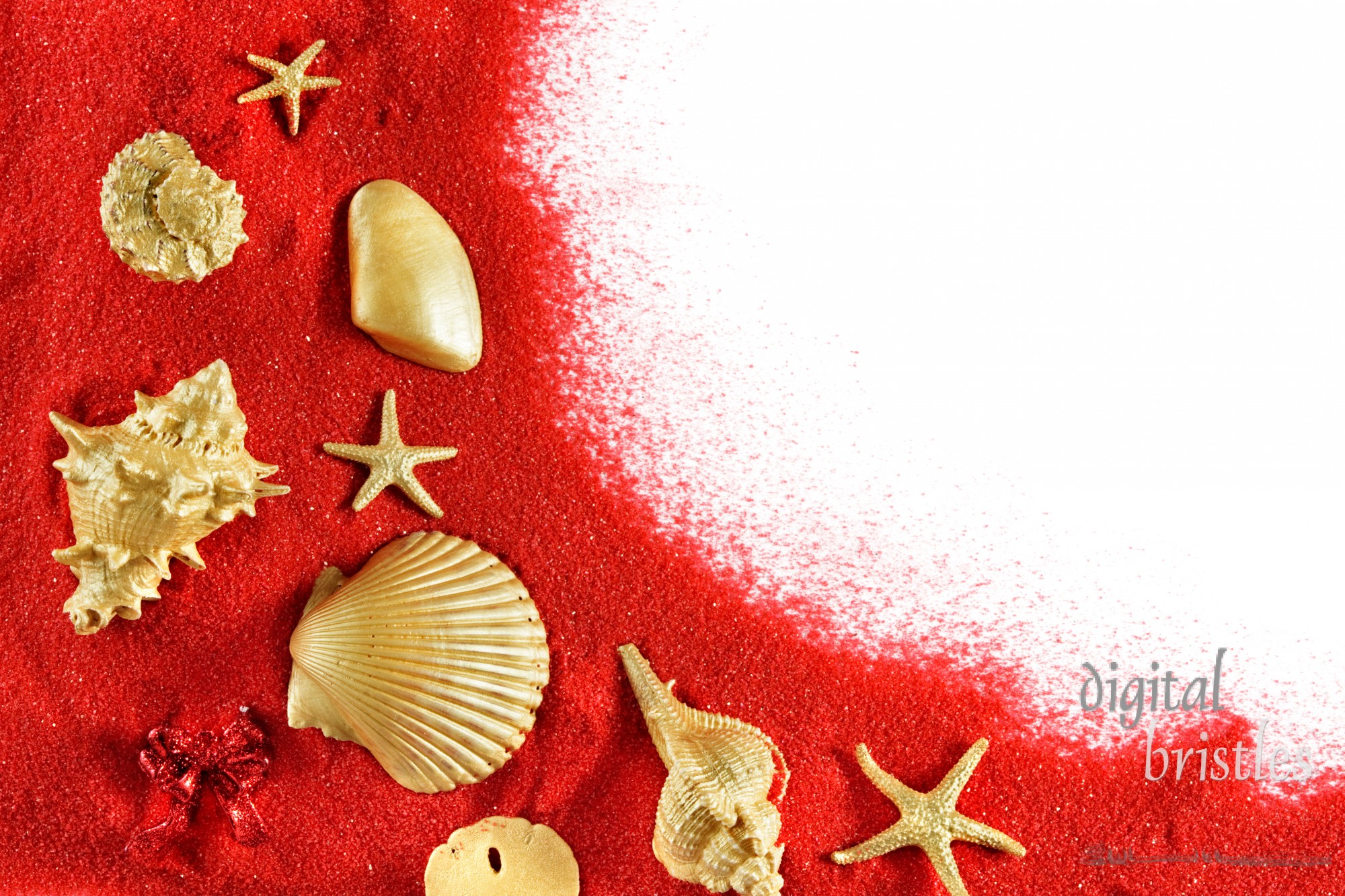 Gold shells, ornaments & starfish on red sand