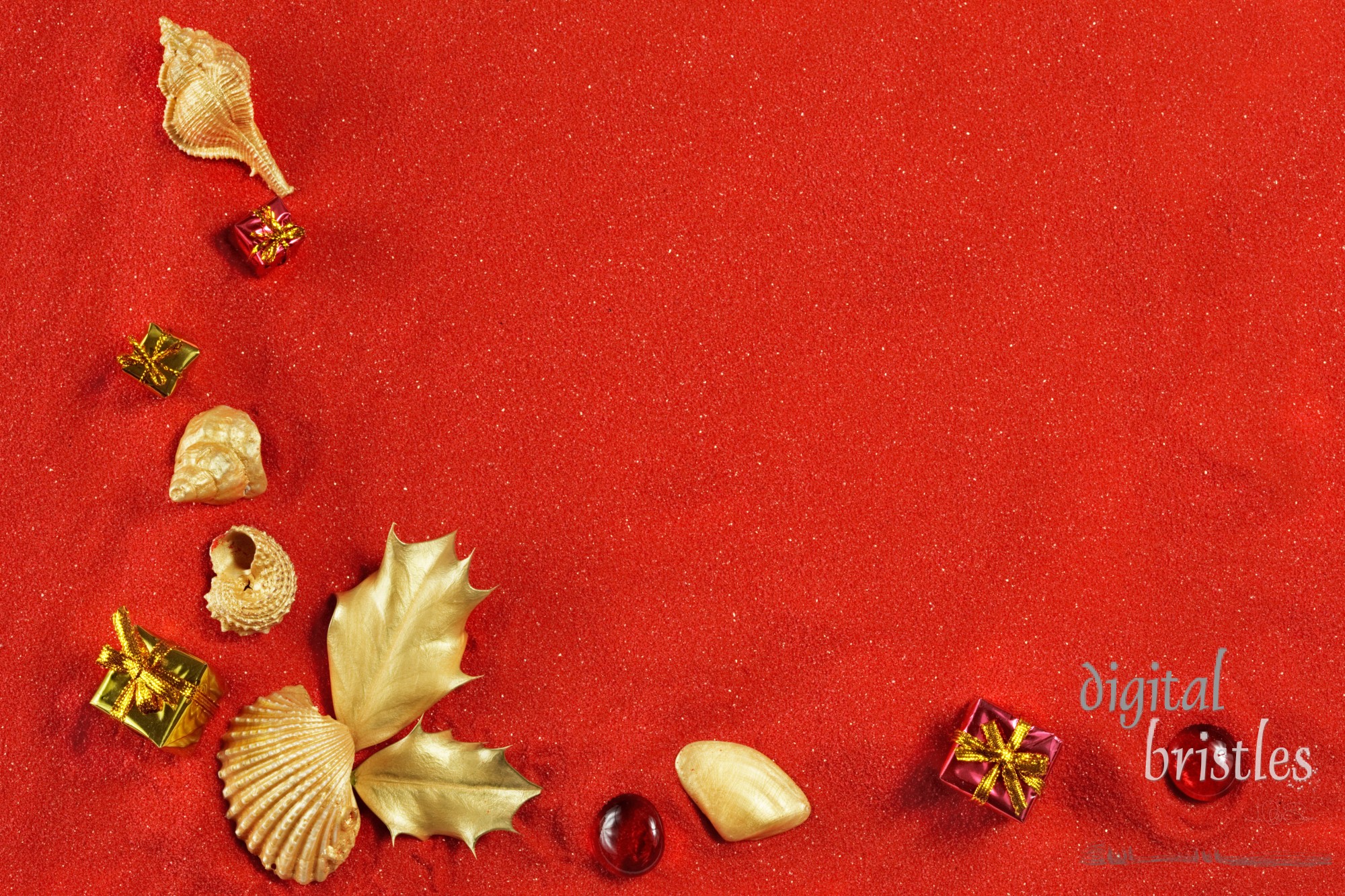 Gold shells, presents & holly on red sand