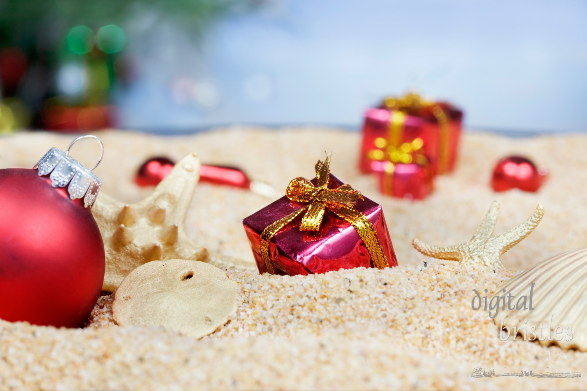 Christmas ornaments in the sand - red packages