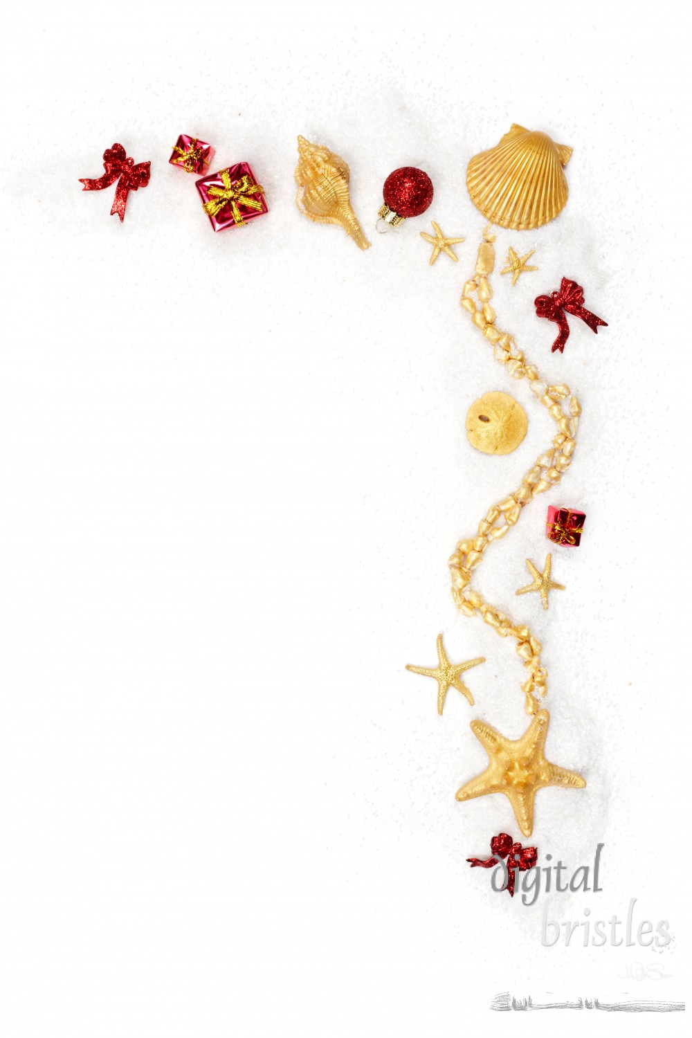 Ornaments and shells painted gold on a white sand background