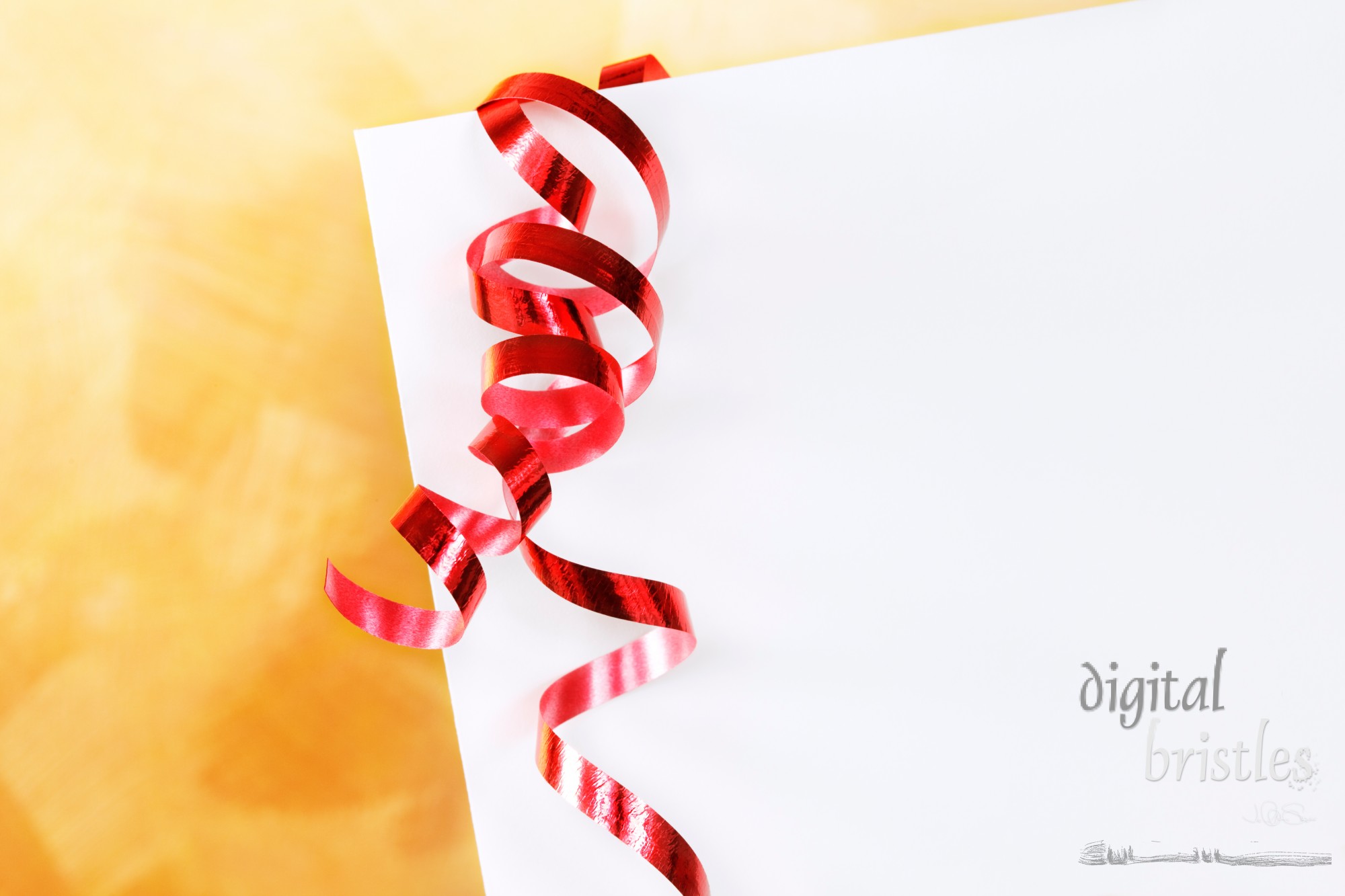 White envelope with red curling ribbon over a gold hand painted background