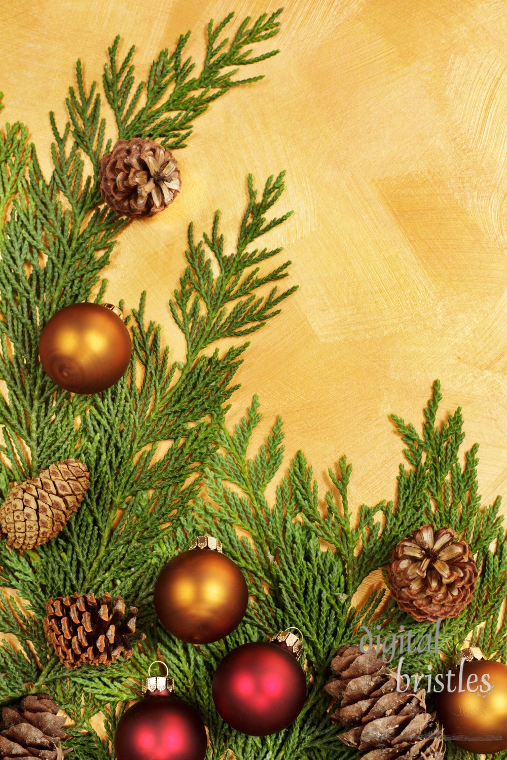 Branches, baubles and pine cones on a hand painted gold background