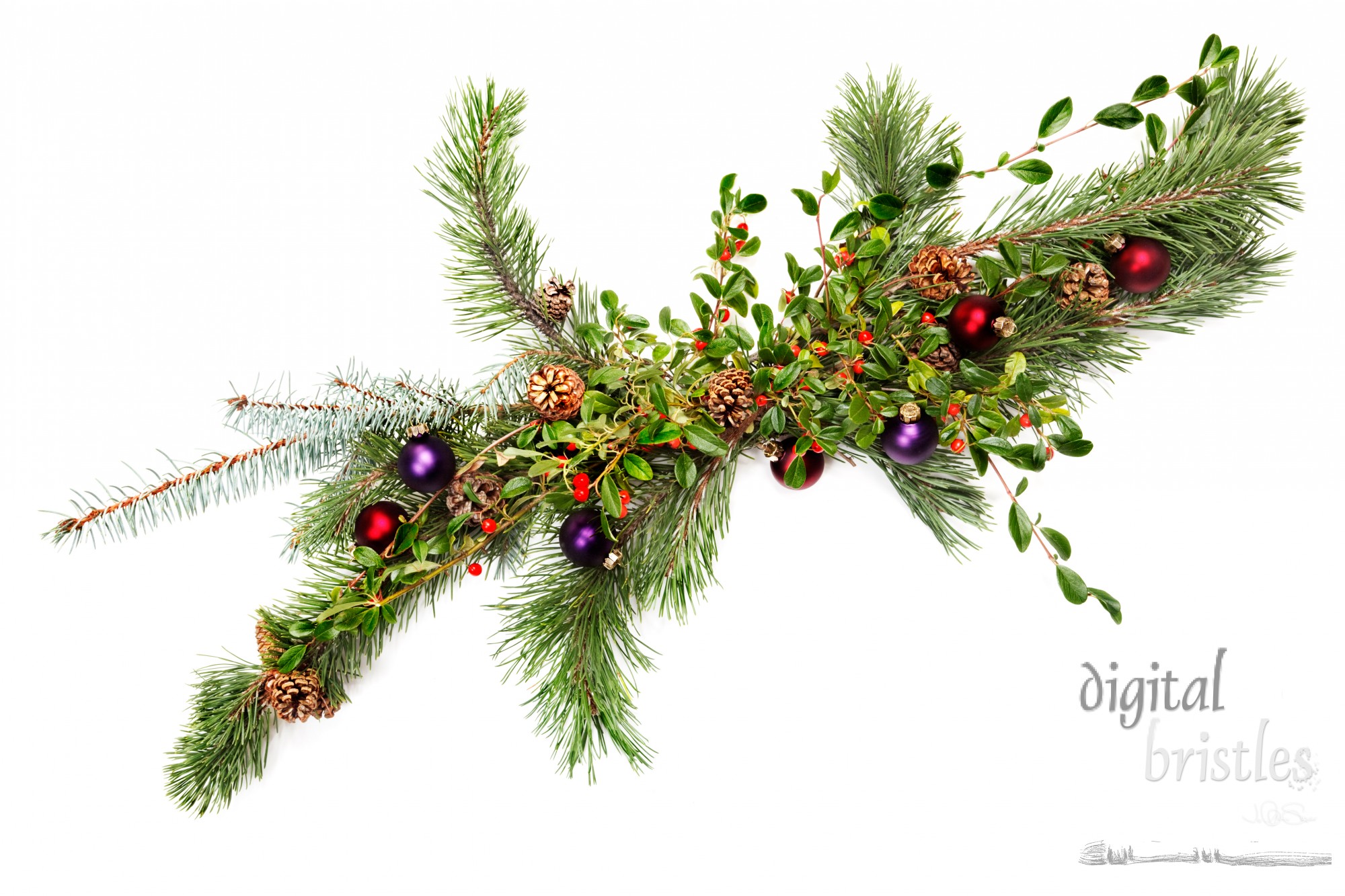 Holiday garland with ornaments, pine & spruce branches, pine cones and evergreen with berries (Common Bearberry/Kinnikinnick) Shot straight down but at an angle to get maximum length in frame.