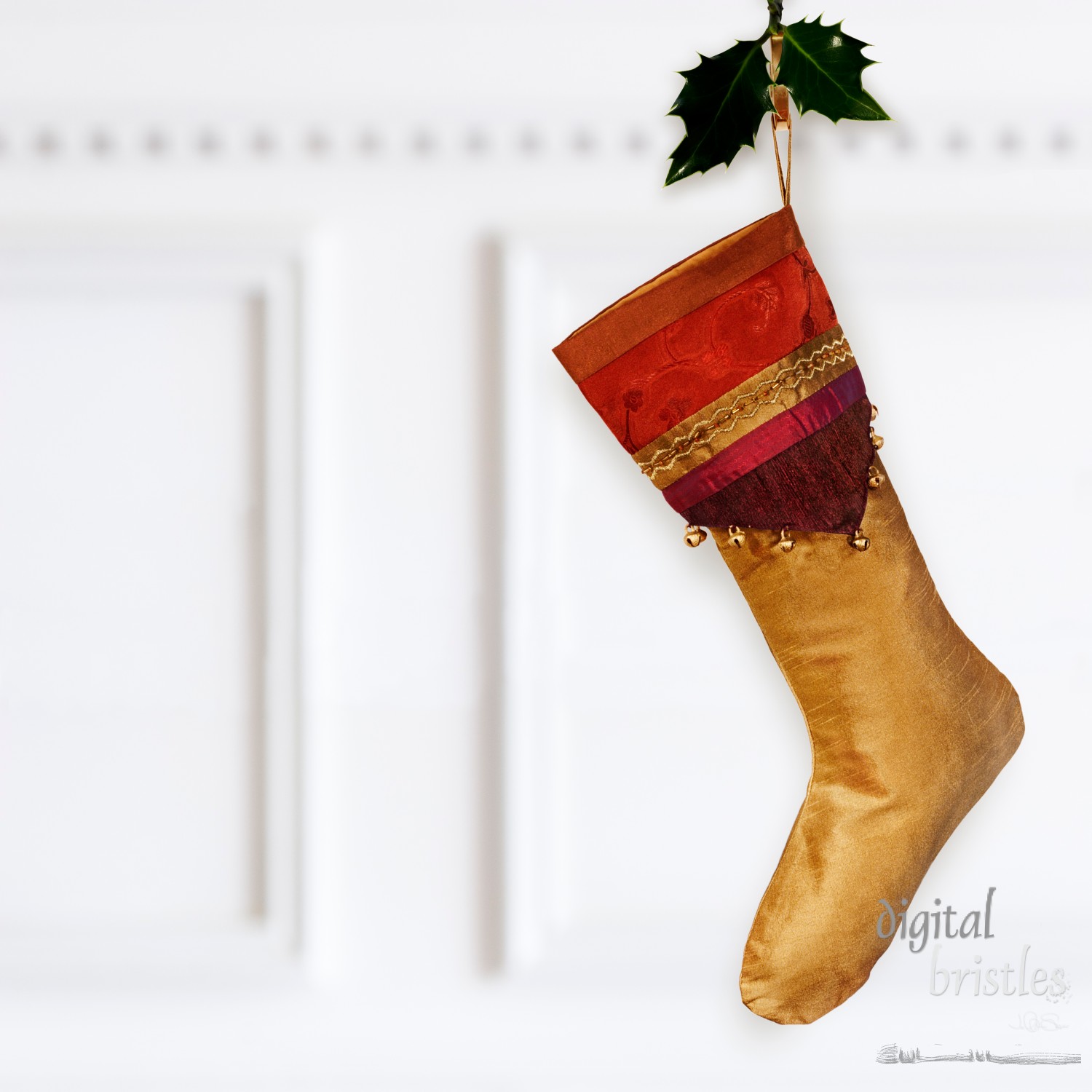 Gold silk Christmas stocking with elaborate cuff hanging by the mantel