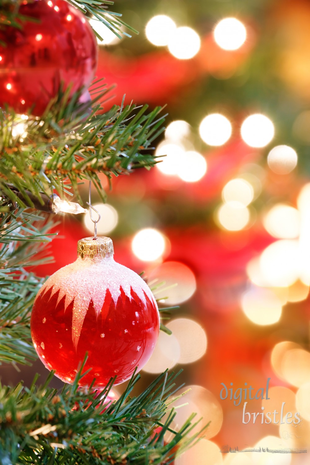 Red and white glass Christmas Tree ornament surrounded by lights