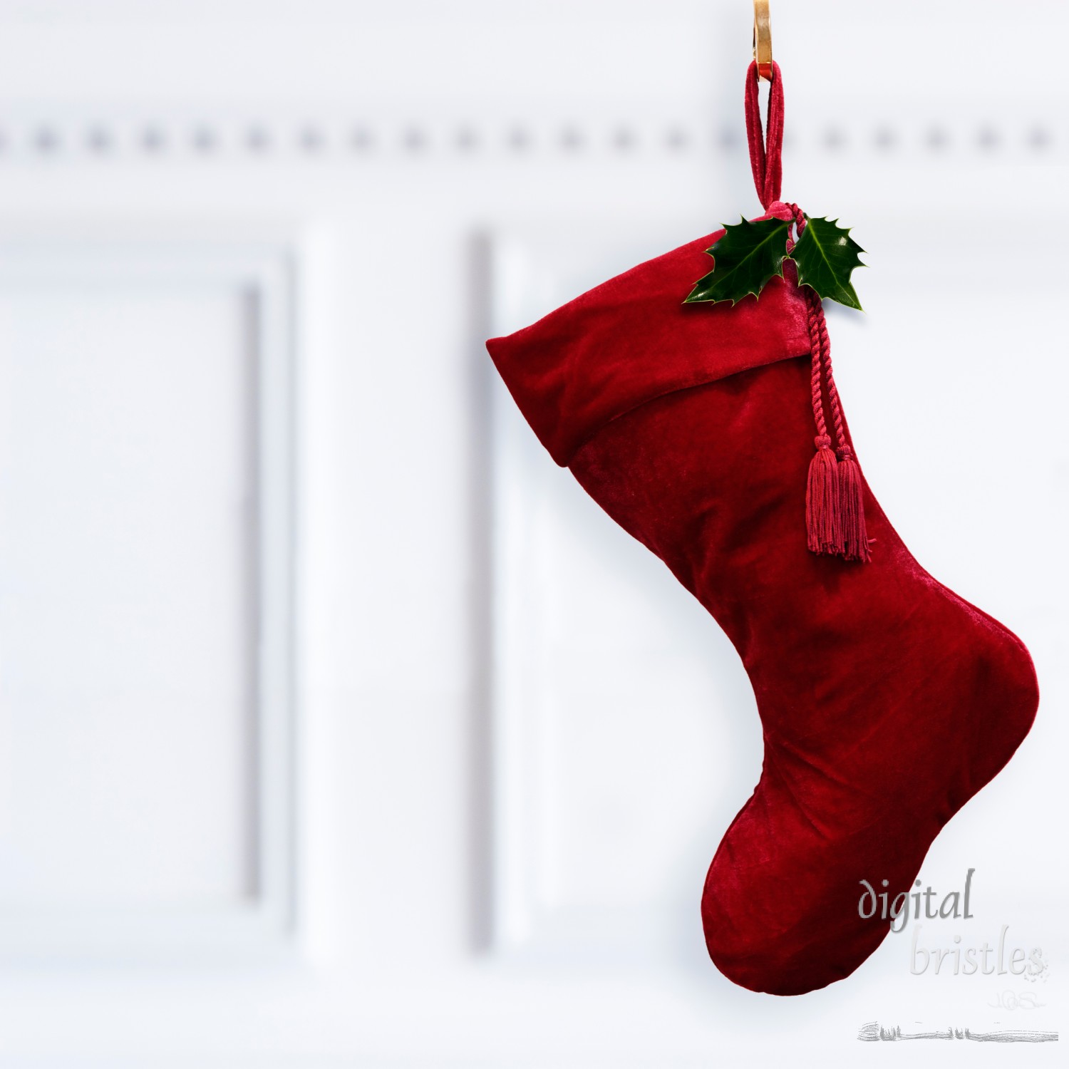 Deep red velvet Christmas stocking, hanging by the fireplace mantel