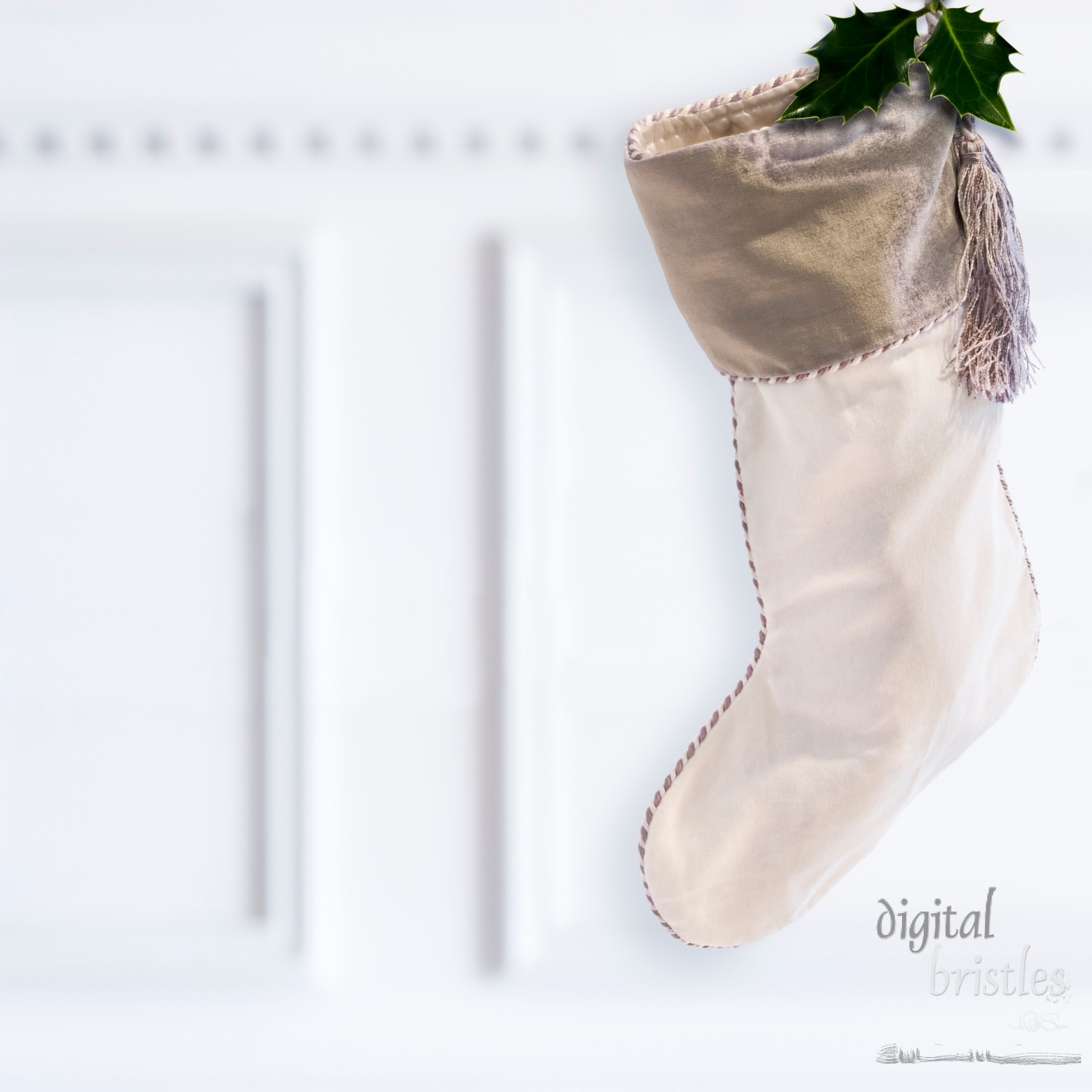 Silvery and white velvet Christmas stocking, hanging by the fireplace mantel